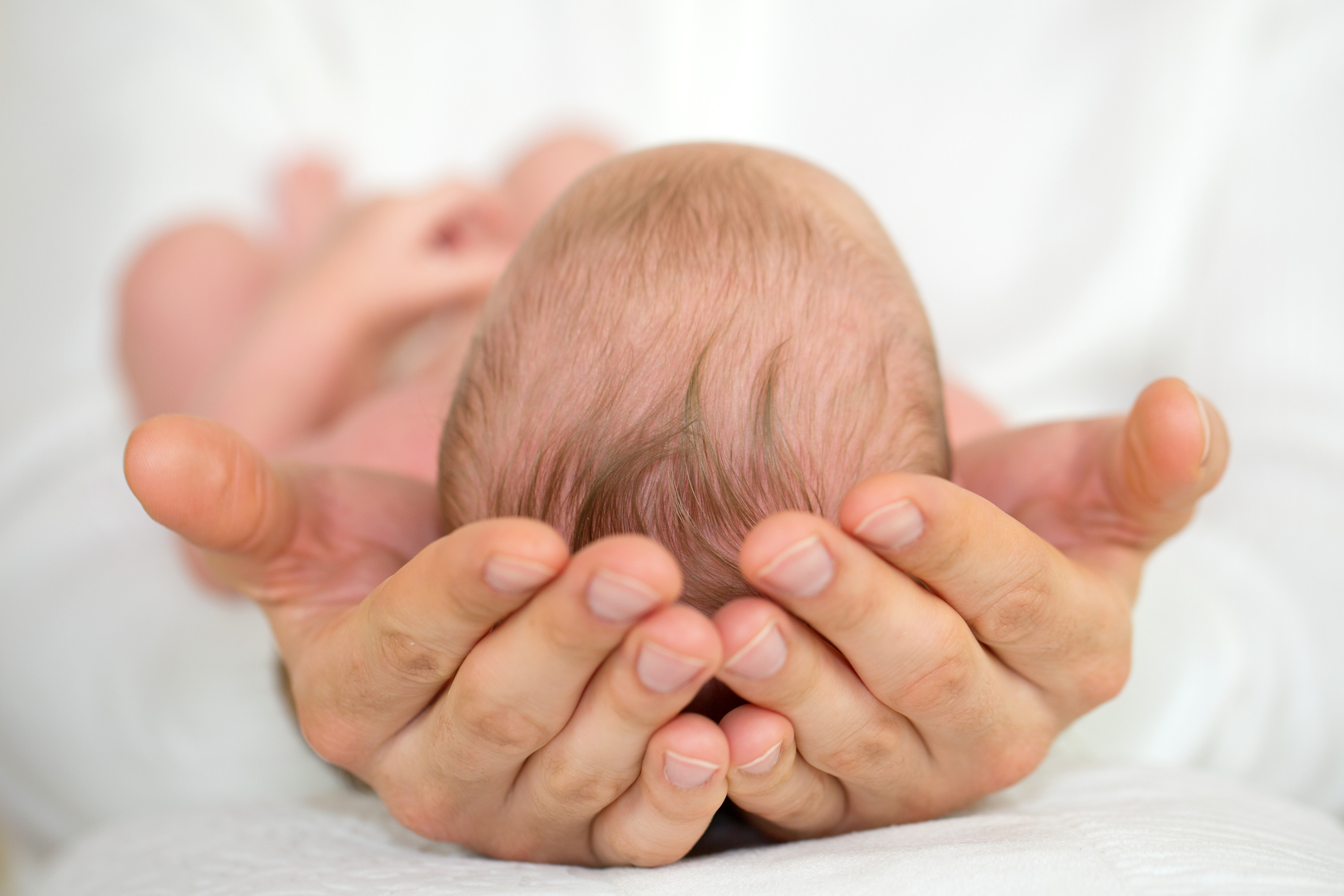 baby in moms hands